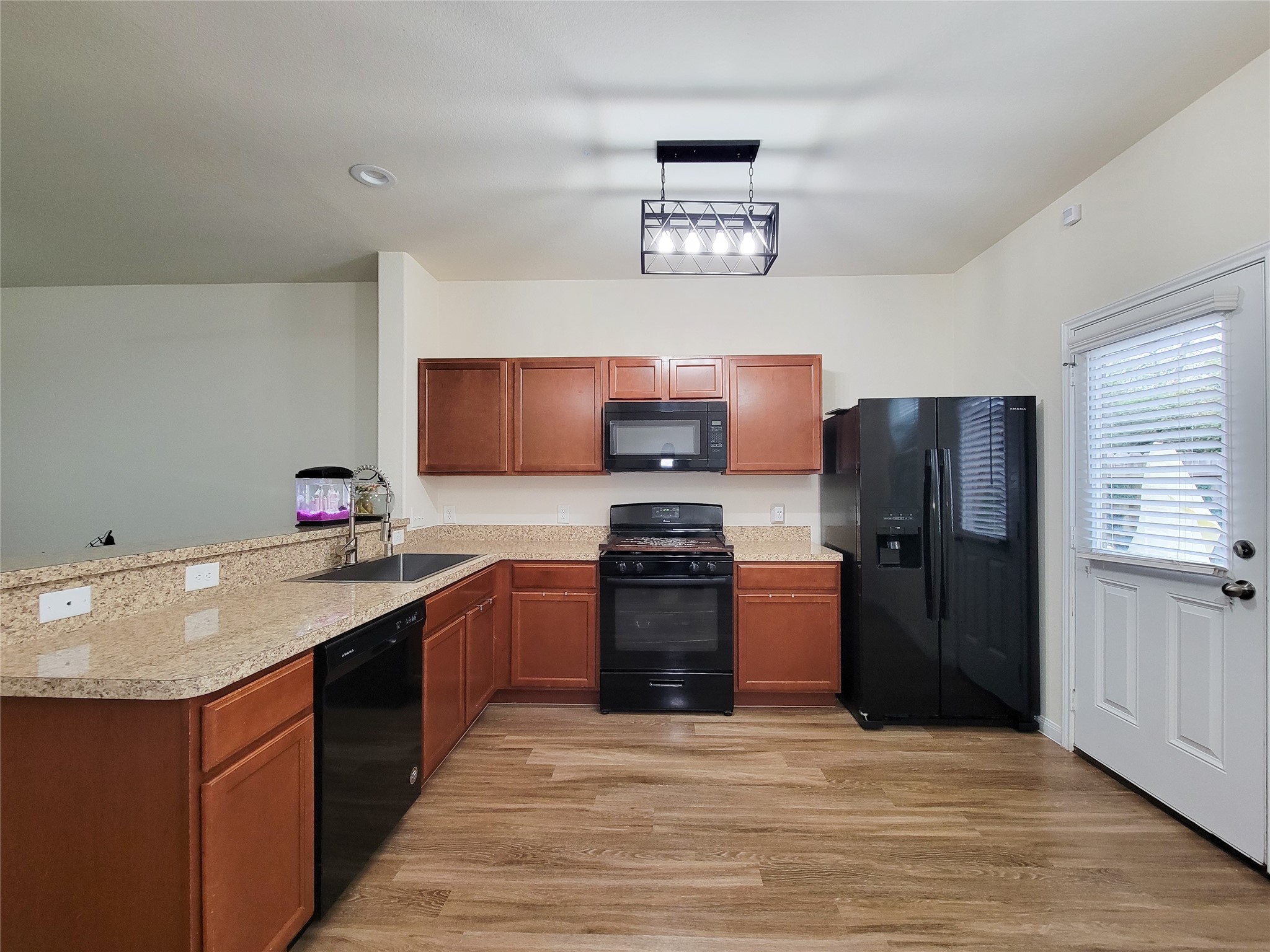 13111 Italian Cypress Trail Houston, TX 77044 - Photo 9 of 17 a kitchen with a sink stove and refrigerator