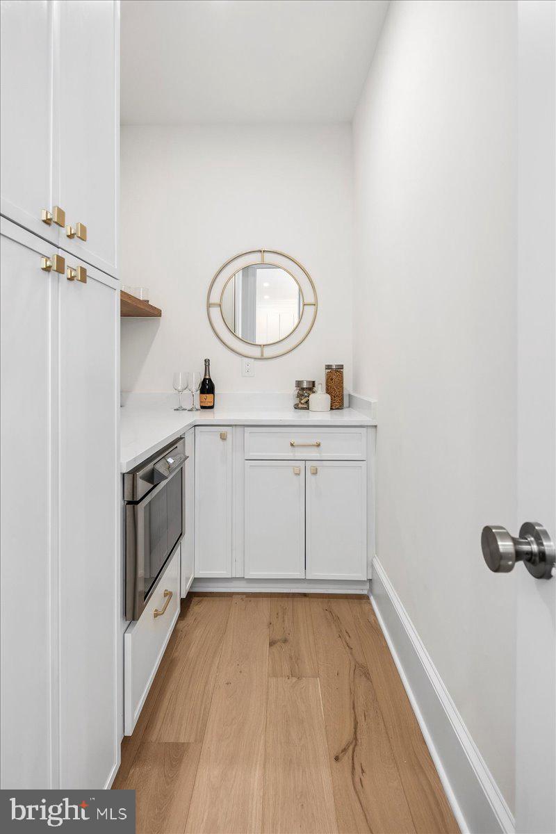 21 Channing Street Northeast Washington, DC 20002 - Photo 14 of 48 a view of a kitchen with sink wooden floor and stainless steel appliances