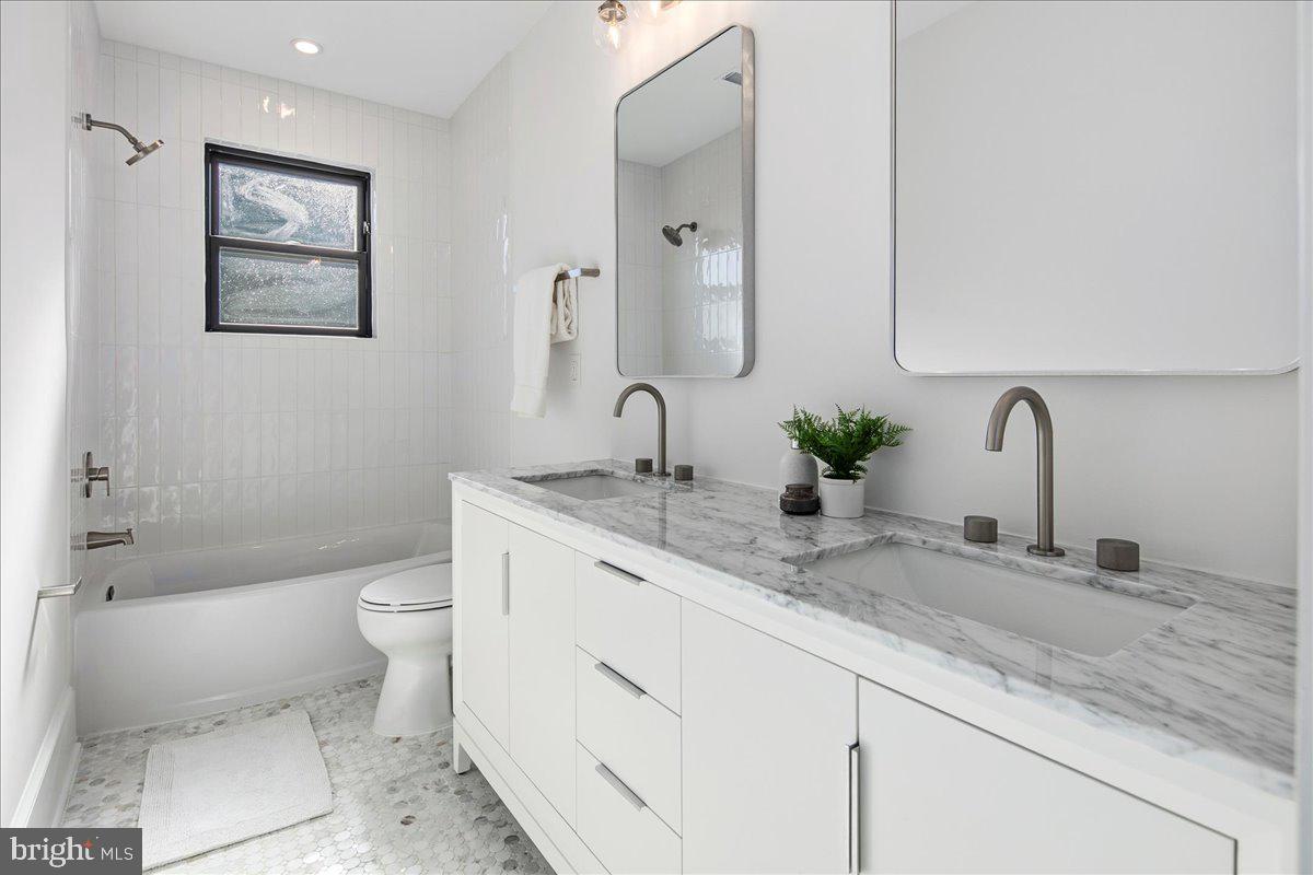 21 Channing Street Northeast Washington, DC 20002 - Photo 23 of 48 a bathroom with a granite countertop toilet sink and mirror