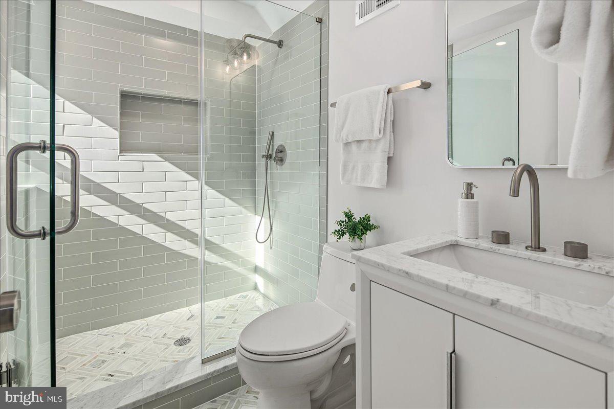 21 Channing Street Northeast Washington, DC 20002 - Photo 32 of 48 a bathroom with a sink and mirror with bathtub