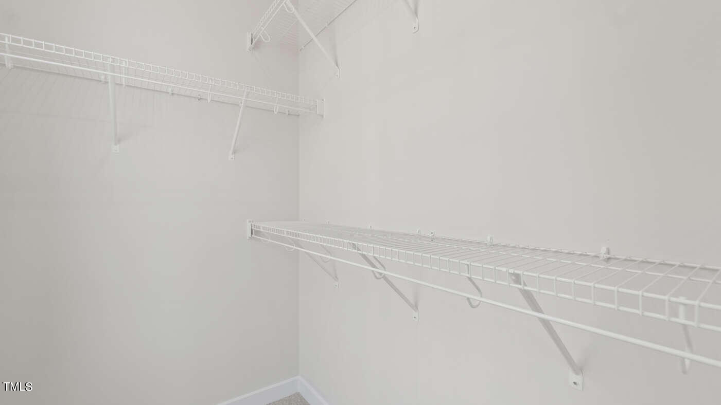 1206 Coach Station Alley, Unit 101 Raleigh, NC 27601 - Photo 11 of 48 a view of a room with racks on the wall