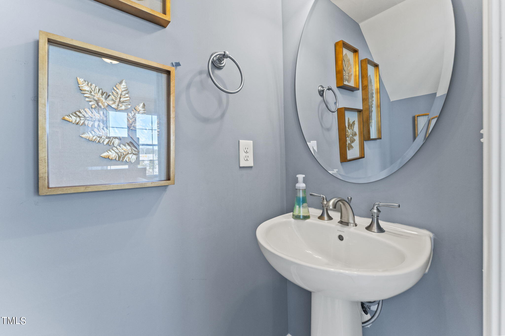 1206 Coach Station Alley, Unit 101 Raleigh, NC 27601 - Photo 14 of 48 a bathroom with a sink and a mirror