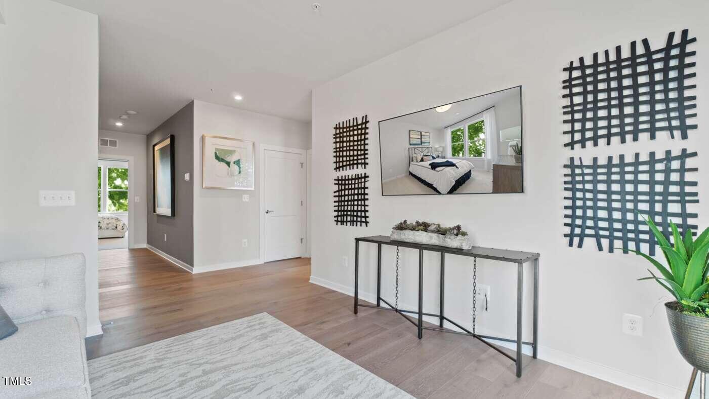 1206 Coach Station Alley, Unit 101 Raleigh, NC 27601 - Photo 16 of 48 a view of a hallway view with wooden floor and staircase