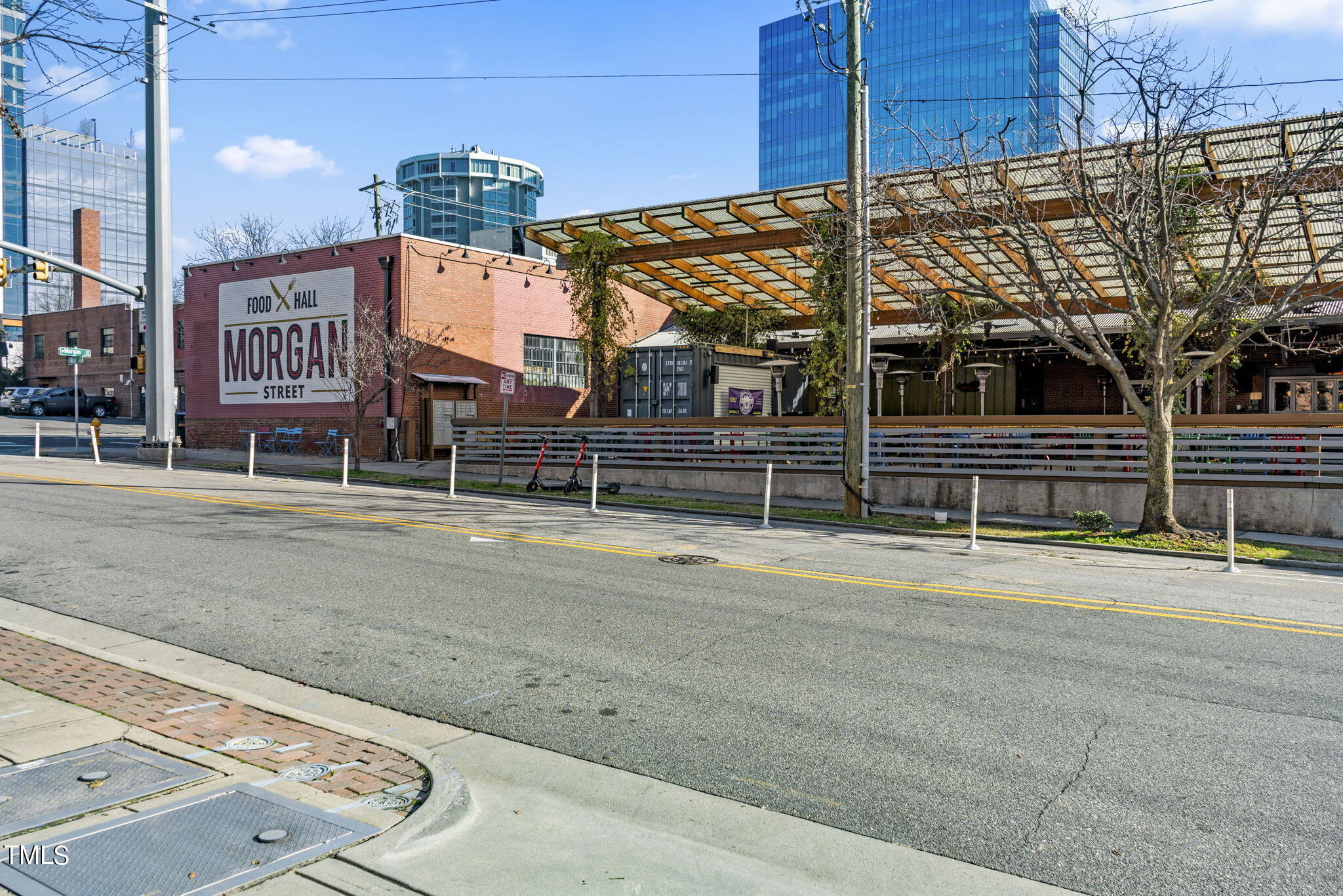 1206 Coach Station Alley, Unit 101 Raleigh, NC 27601 - Photo 37 of 48 a view of a street with wooden fence