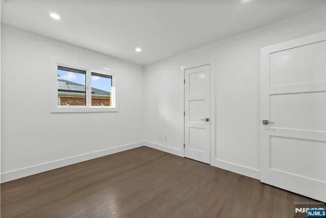 a bathroom with a sink a toilet a mirror and shower