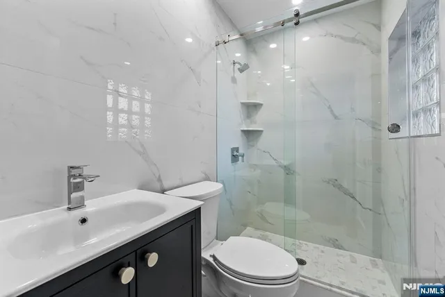 a view of a room with wooden floor and a bathroom