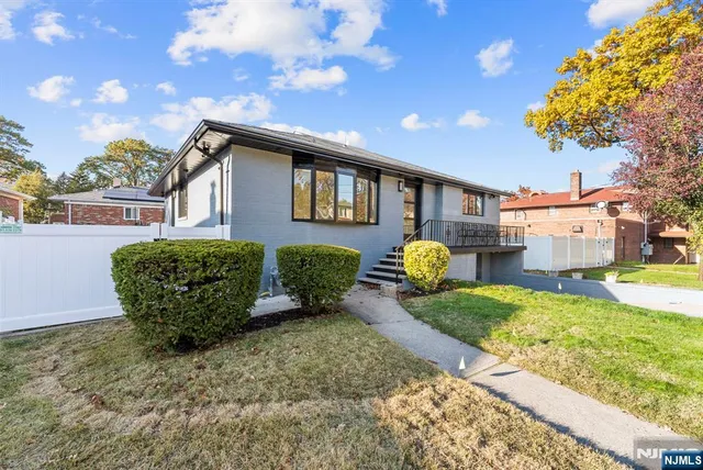 a view of kitchen with sink and refrigerator