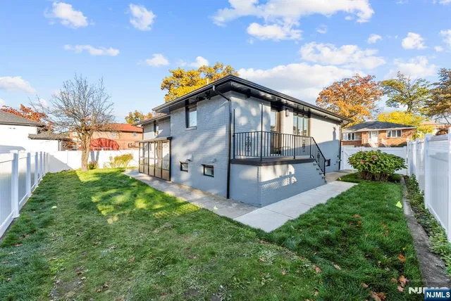 a large kitchen with stainless steel appliances a large counter top a stove and a refrigerator