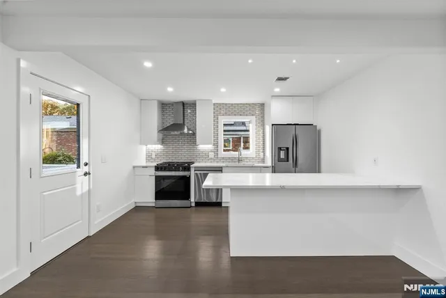 a view of room with wooden floor and window
