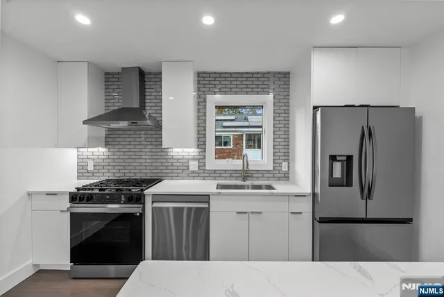 a view of an empty room with a painting on the wall