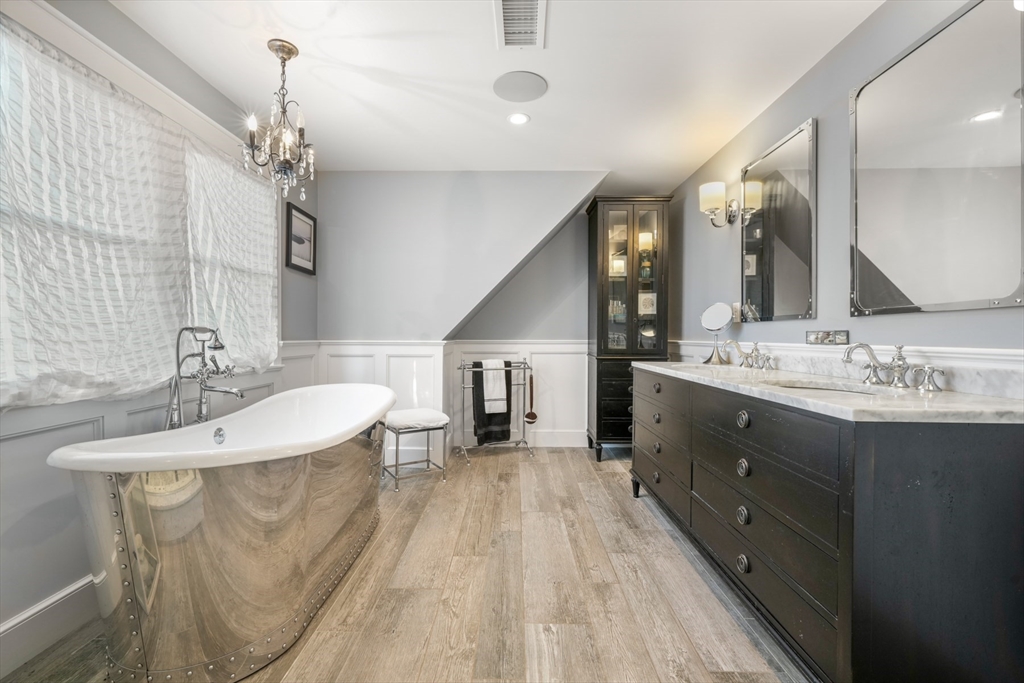 29 Bay Shore Road Hyannis, MA 02601 - Photo 27 of 42 a spacious bathroom with a granite countertop sink a mirror and a shower