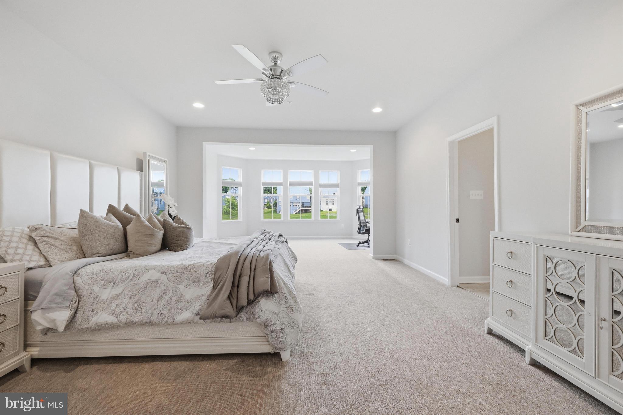 5707 Hawk Ridge Road Frederick, MD 21704 - Photo 37 of 109 a spacious bedroom with a large bed and a chandelier