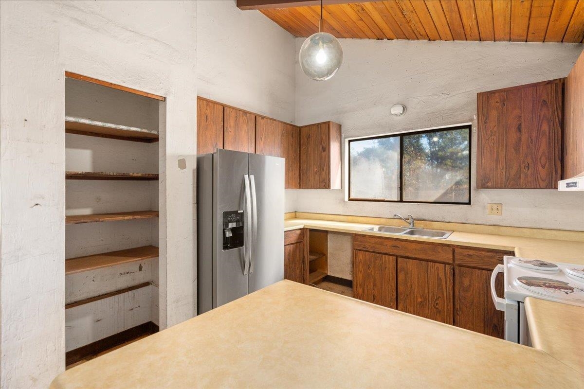 2040 Kanakanui Road Kihei, HI 96753 - Photo 4 of 22 a kitchen with stainless steel appliances a refrigerator and a sink