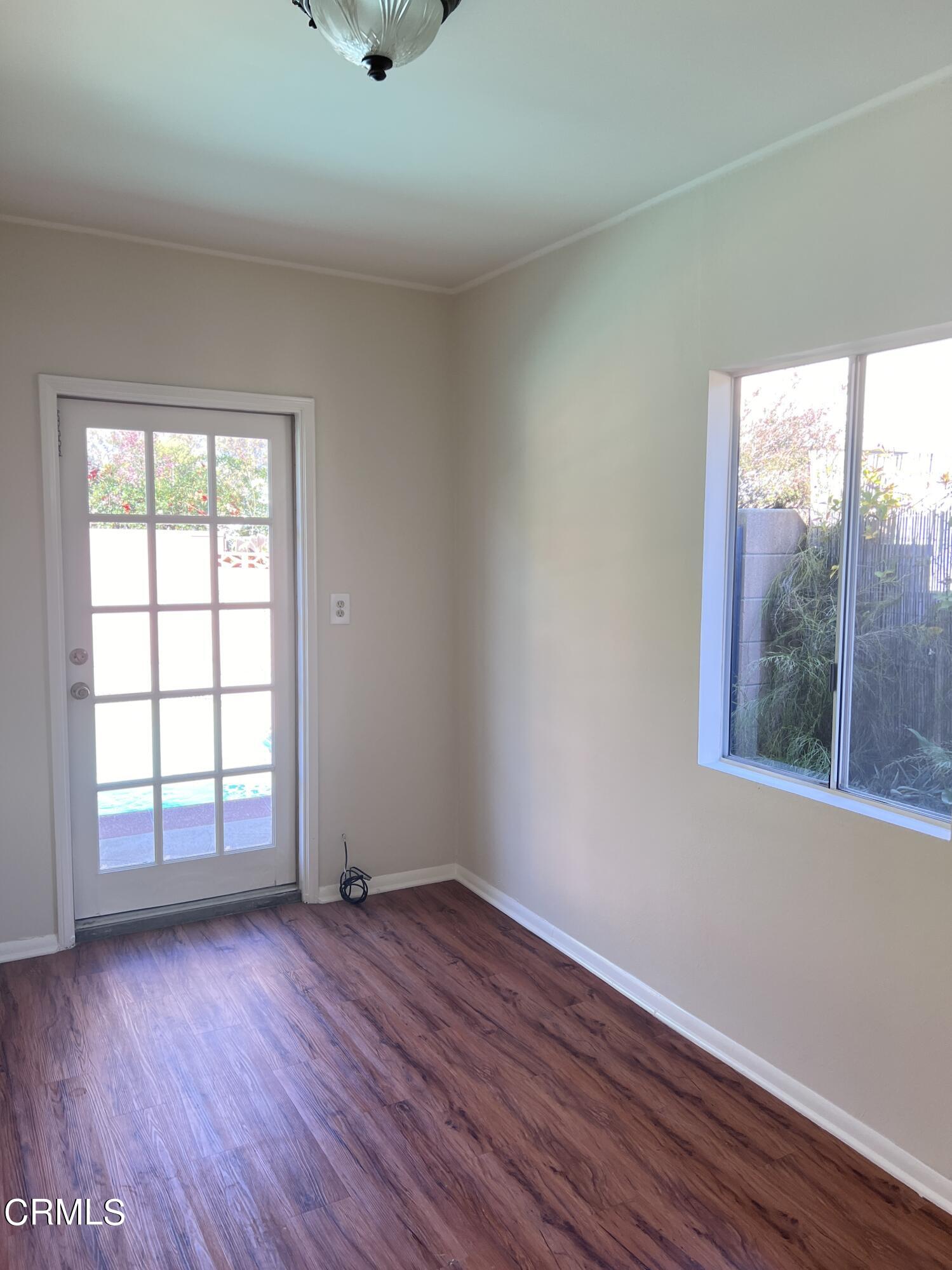 3159 Piccolo Street Pasadena, CA 91107 - Photo 11 of 14 an empty room with wooden floor and windows