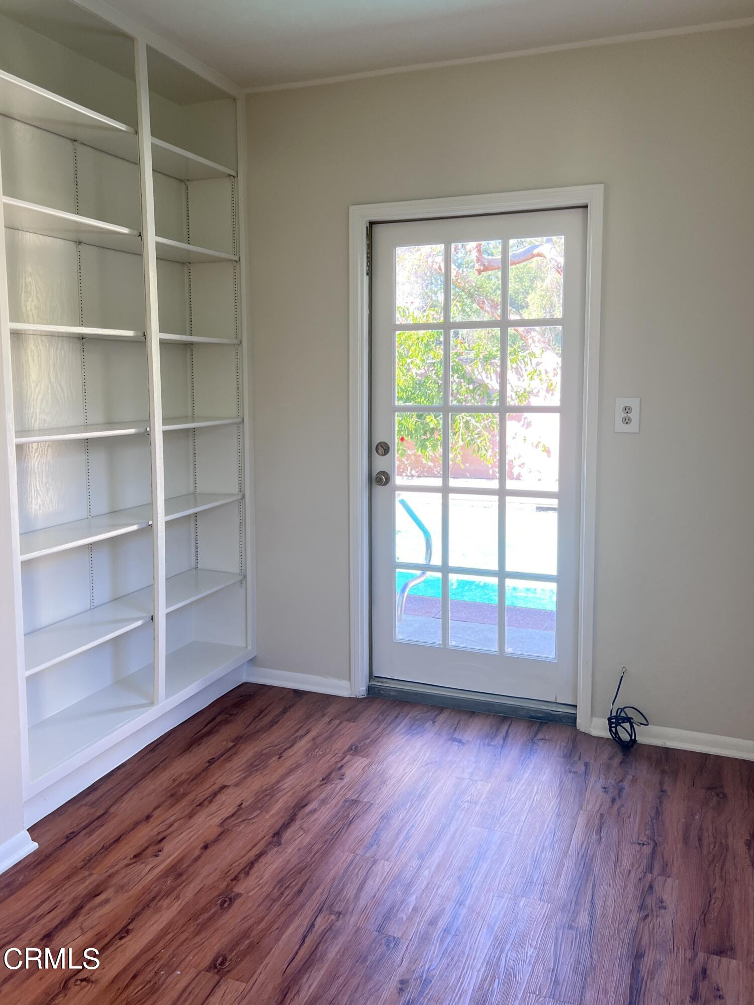 3159 Piccolo Street Pasadena, CA 91107 - Photo 12 of 14 a view of an empty room with a window and wooden floor