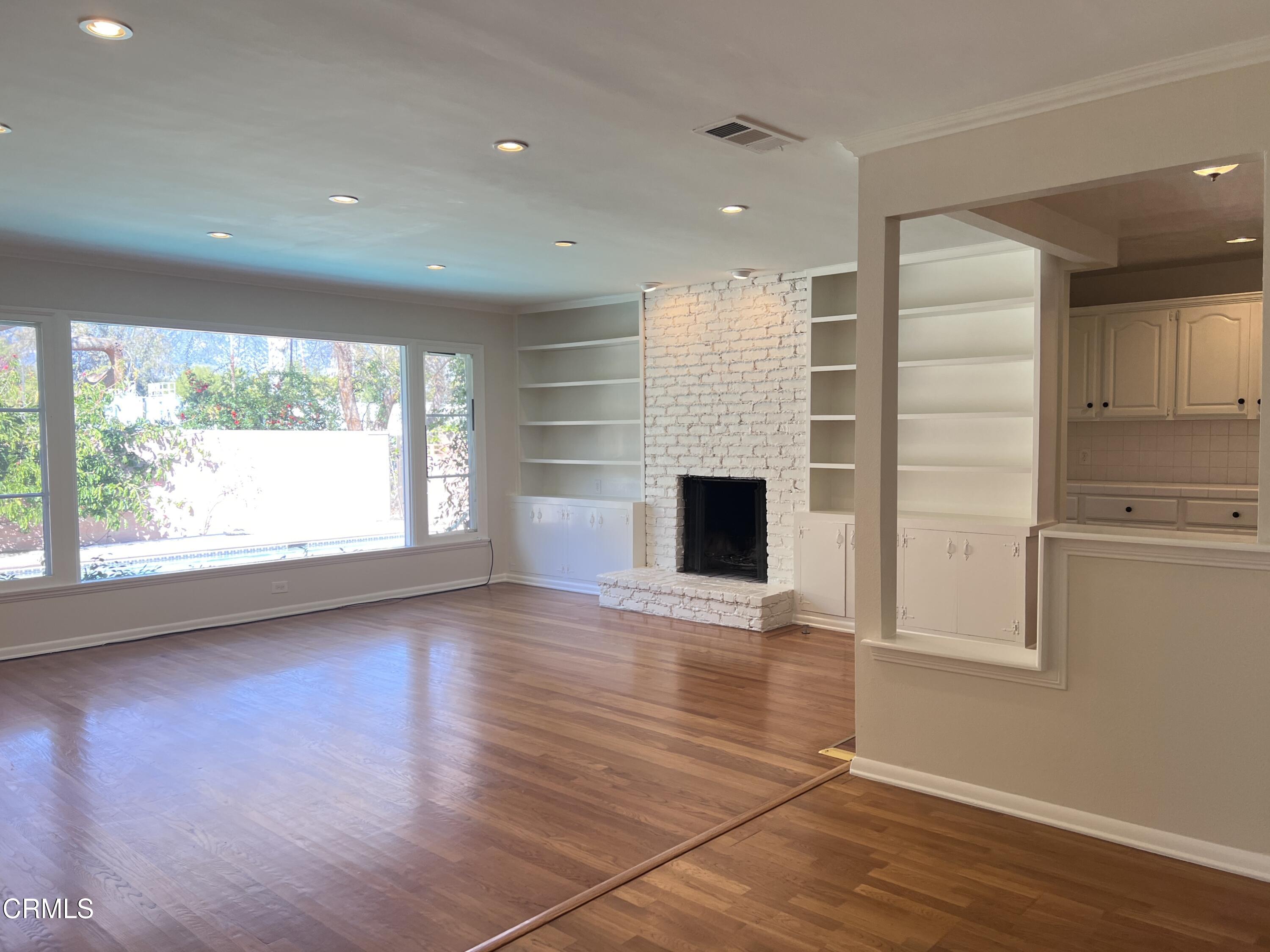 3159 Piccolo Street Pasadena, CA 91107 - Photo 2 of 14 an empty room with wooden floor and windows