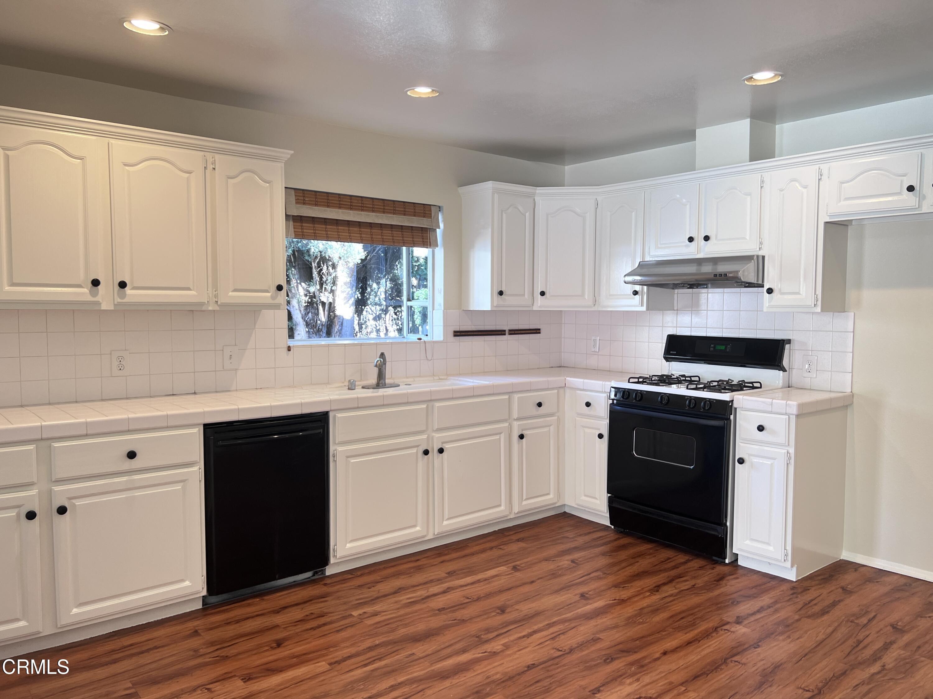 3159 Piccolo Street Pasadena, CA 91107 - Photo 4 of 14 a kitchen with cabinets wooden floor and stainless steel appliances