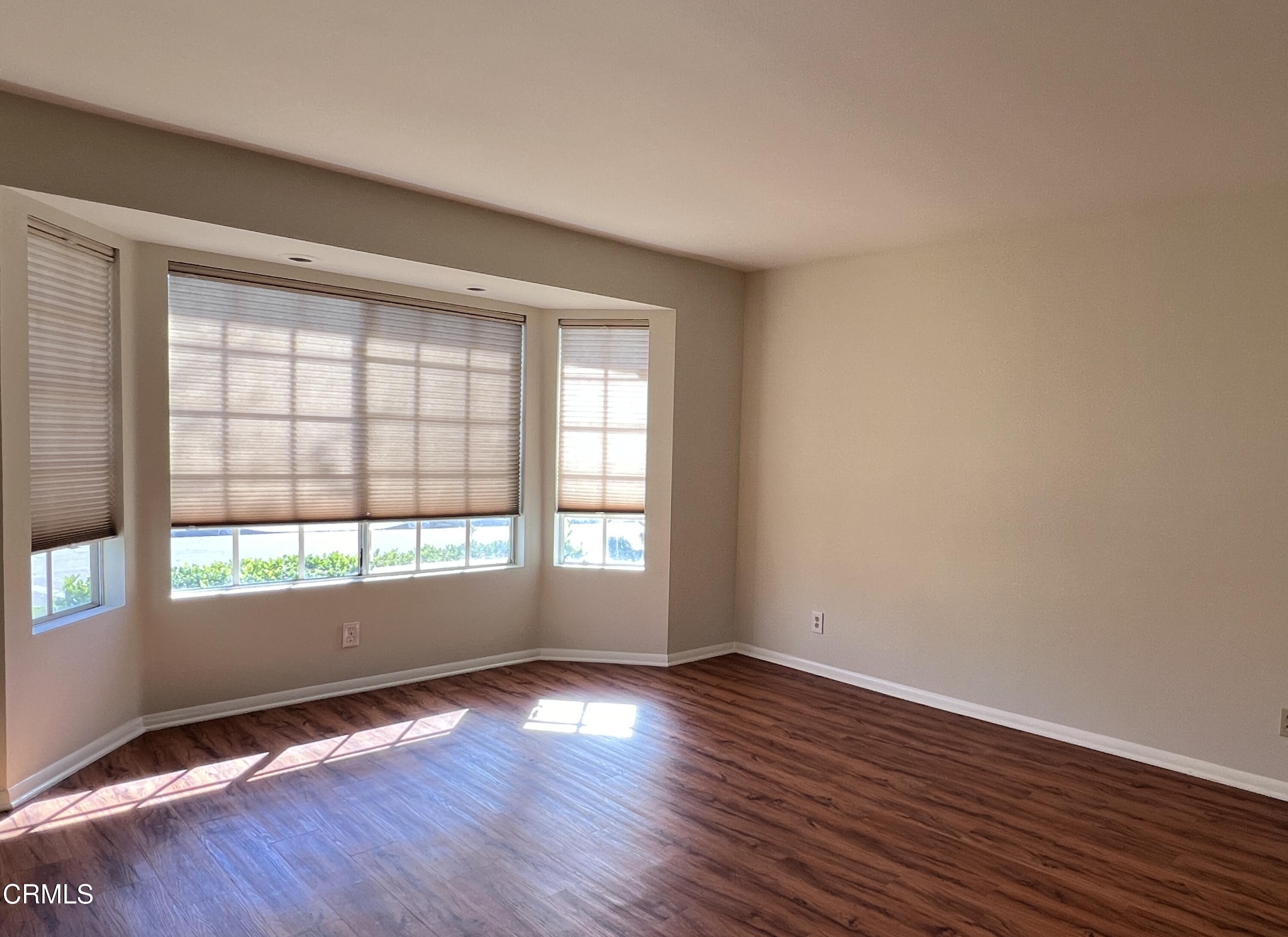 3159 Piccolo Street Pasadena, CA 91107 - Photo 5 of 14 an empty room with wooden floor and windows