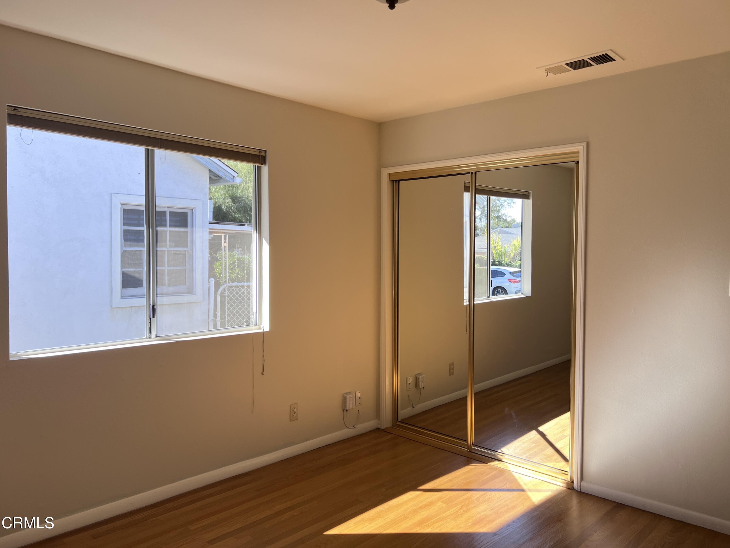 3159 Piccolo Street Pasadena, CA 91107 - Photo 7 of 14 a view of an empty room with wooden floor and a window