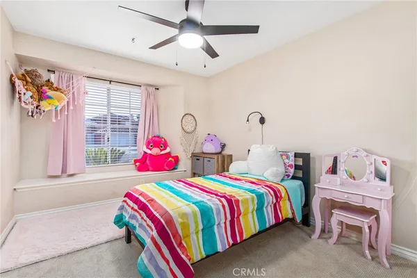 a bedroom with a bed closet and window