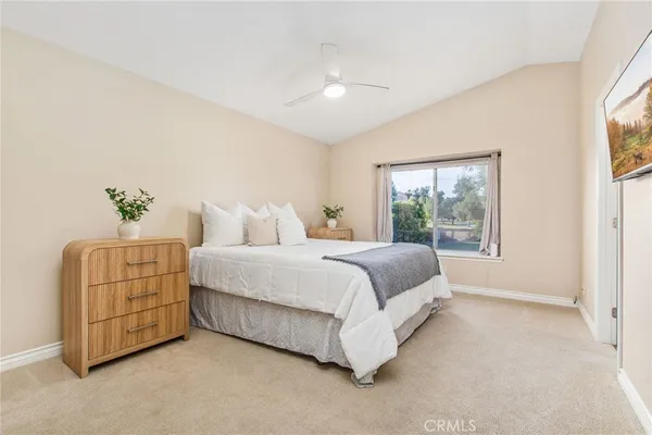 a spacious bedroom with a bed and a couch