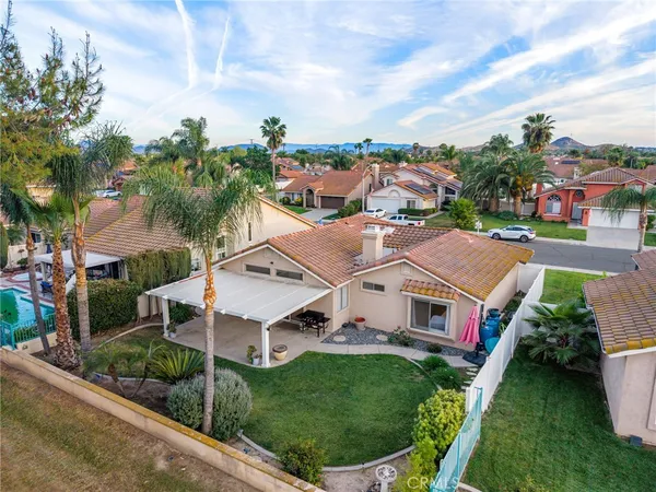 a aerial view of a house with a big yard plants and large trees