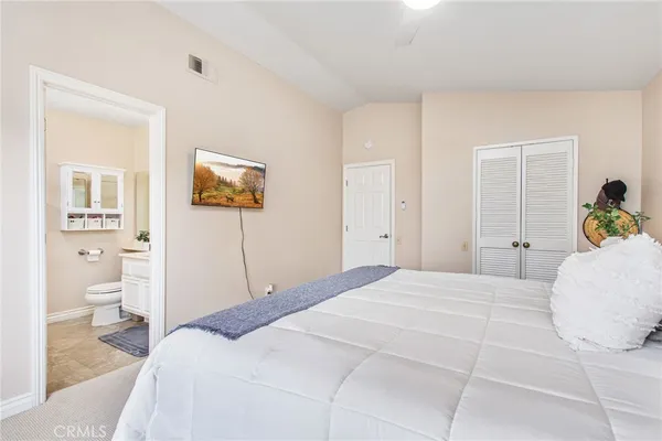a bedroom with a bed and a painting on the wall