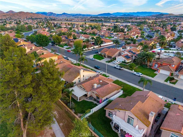an aerial view of residential houses with city view