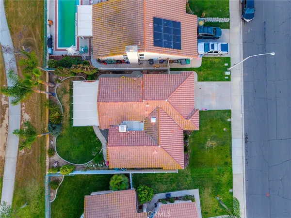 an aerial view of a house with garden space and street view