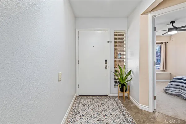 a view of a hallway with potted plant and a window