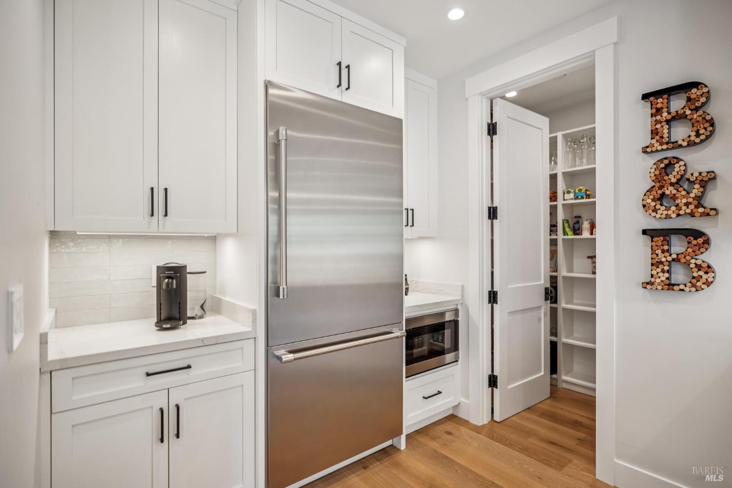 85 Harriet Way Tiburon, CA 94920 - Photo 12 of 44 a kitchen with stainless steel appliances a refrigerator and cabinets