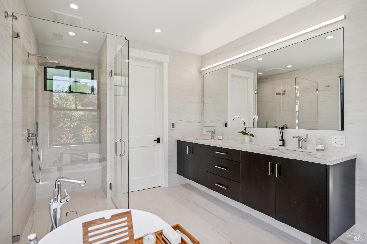 85 Harriet Way Tiburon, CA 94920 - Photo 21 of 44 a spacious bathroom with a double vanity sink toilet mirror and shower