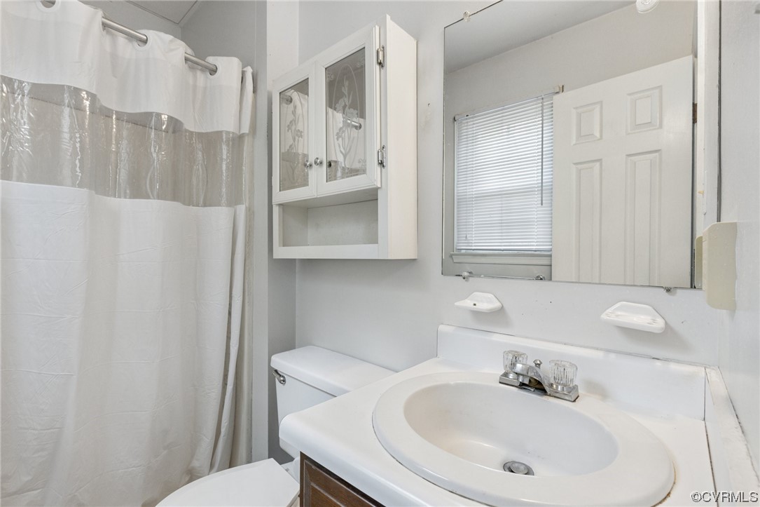 4906 Alberta Road Chesterfield, VA 23832 - Photo 12 of 21 a bathroom with a sink a toilet and shower curtain