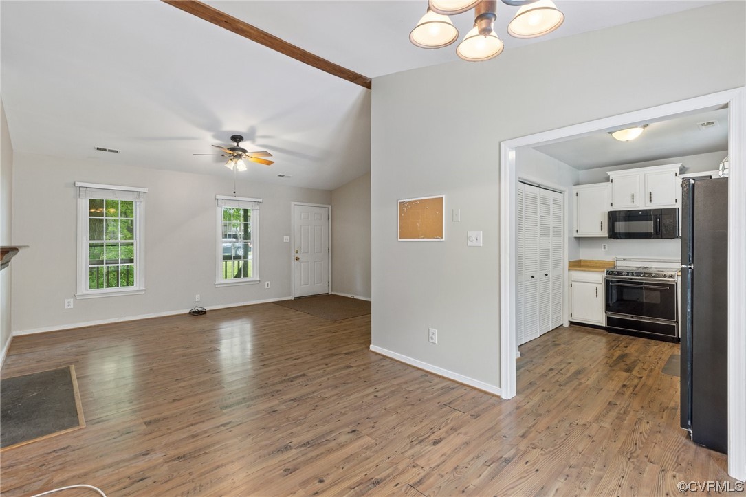 4906 Alberta Road Chesterfield, VA 23832 - Photo 9 of 21 a view of a kitchen with a stove cabinets a ceiling fan and wooden floor