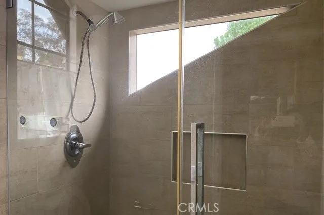 a bathroom with a glass shower door