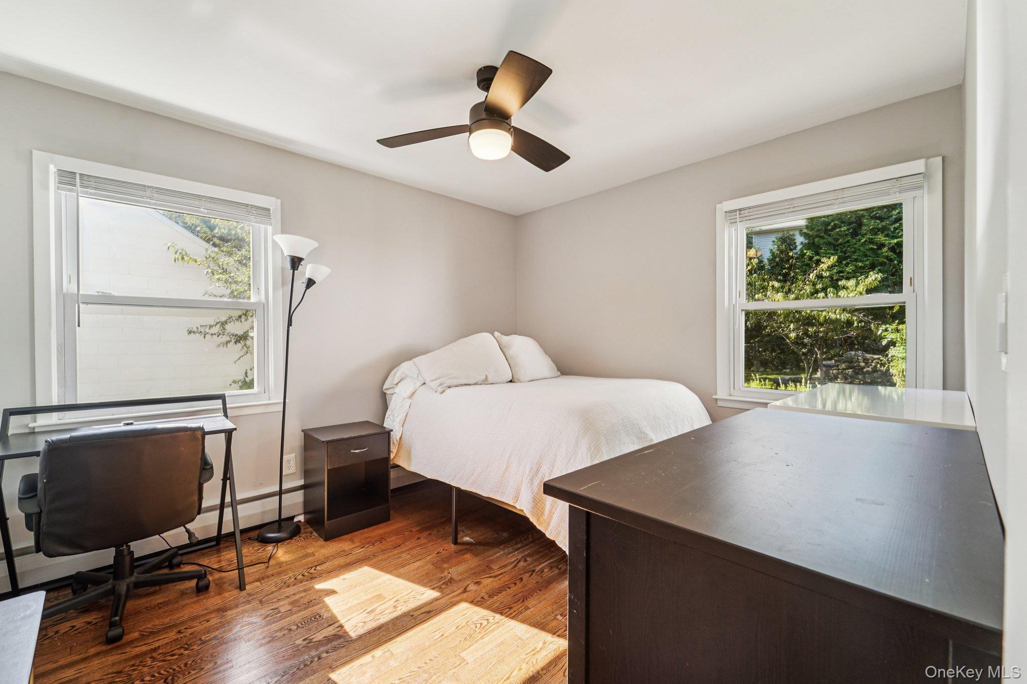 252 County Center Road White Plains, NY 10603 - Photo 15 of 44 Bedroom with light wood-style floors, ceiling fan, a baseboard heating unit, and a desk
