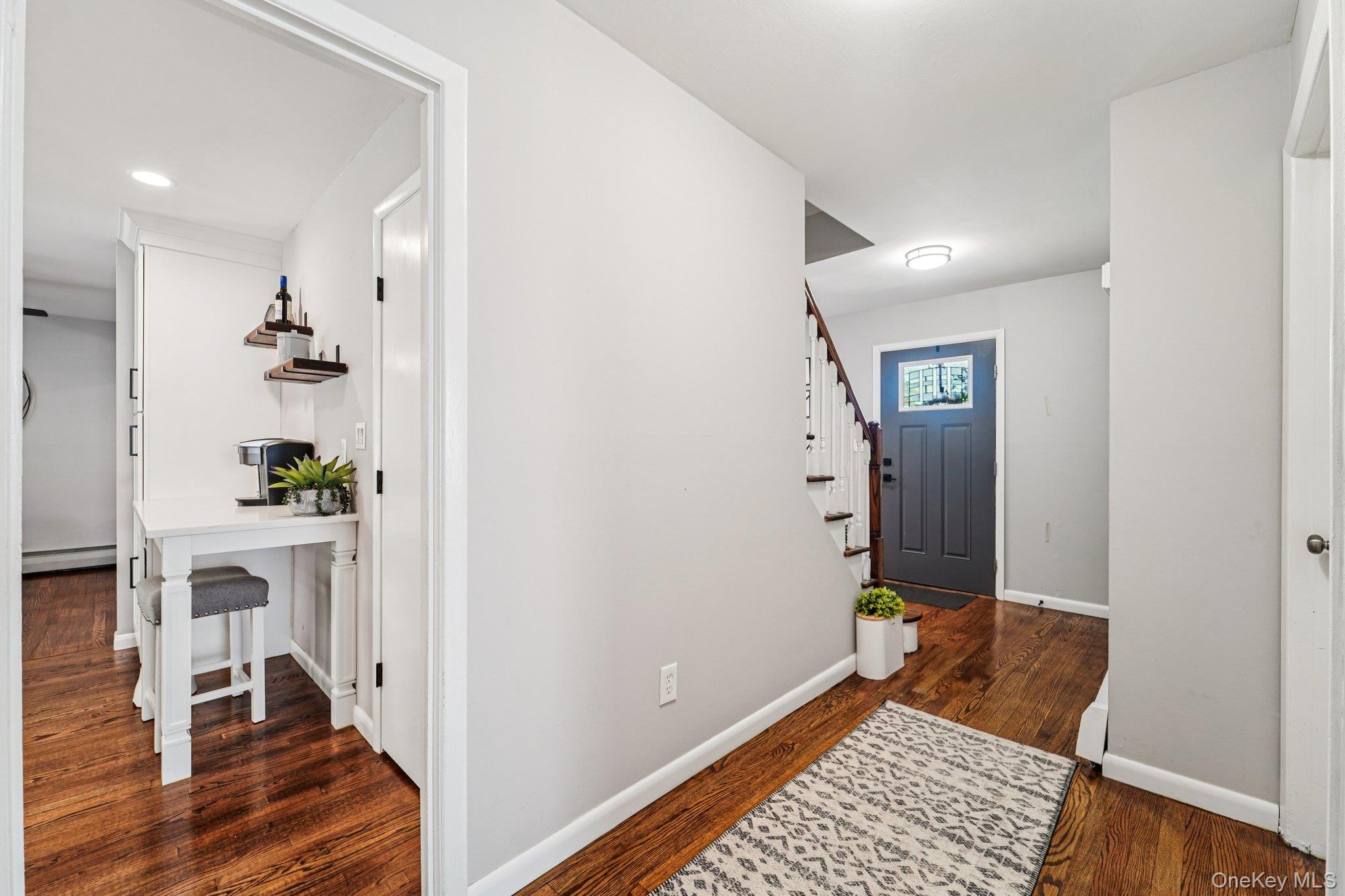 252 County Center Road White Plains, NY 10603 - Photo 16 of 44 Foyer entrance with stairs, dark wood-type flooring, and baseboard heating