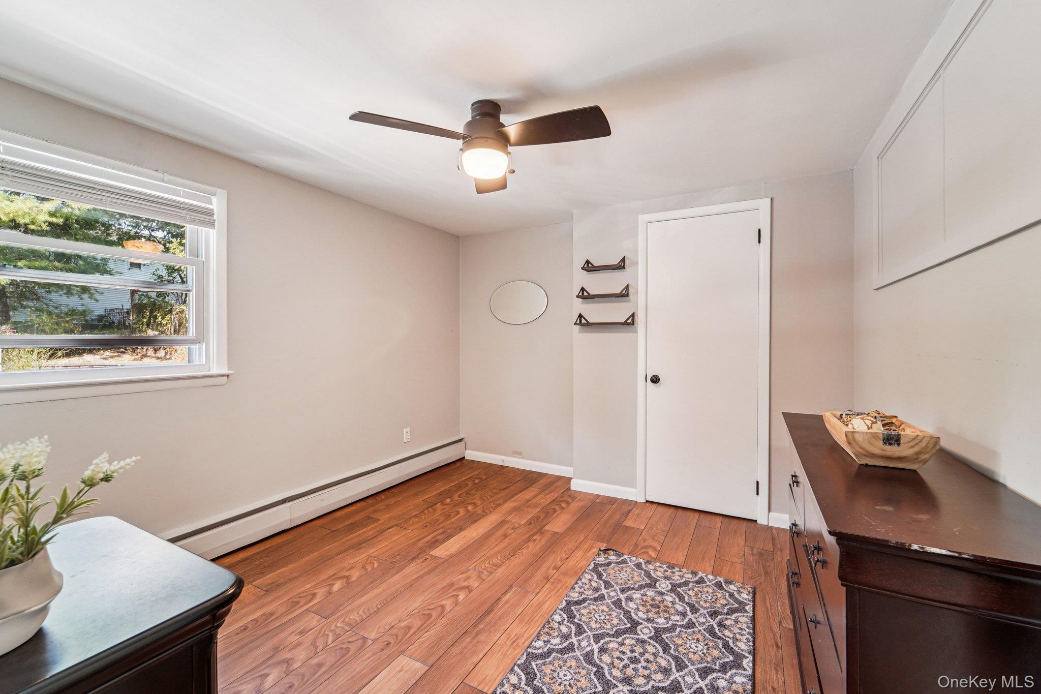 252 County Center Road White Plains, NY 10603 - Photo 18 of 44 Sitting room with light wood-style floors, a baseboard heating unit, and ceiling fan