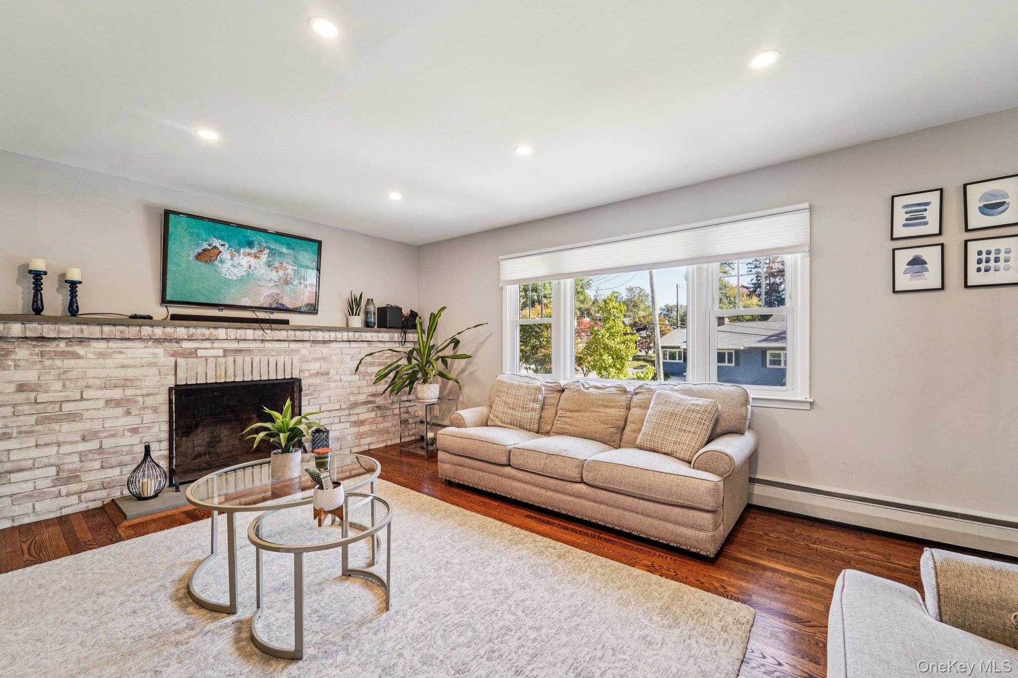 252 County Center Road White Plains, NY 10603 - Photo 2 of 44 Living area with a baseboard radiator, dark wood-type flooring, recessed lighting, and a fireplace