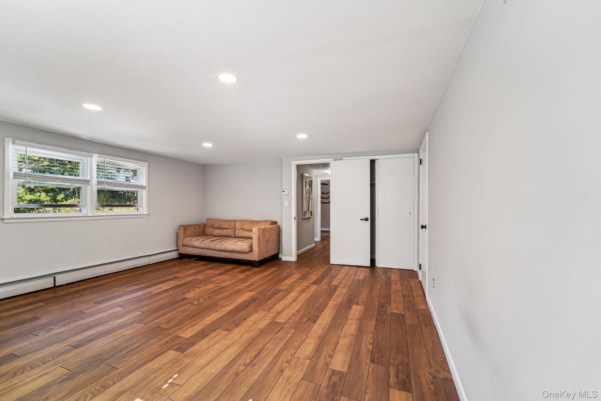 252 County Center Road White Plains, NY 10603 - Photo 27 of 44 Sitting room featuring wood-type flooring, recessed lighting, and baseboard heating