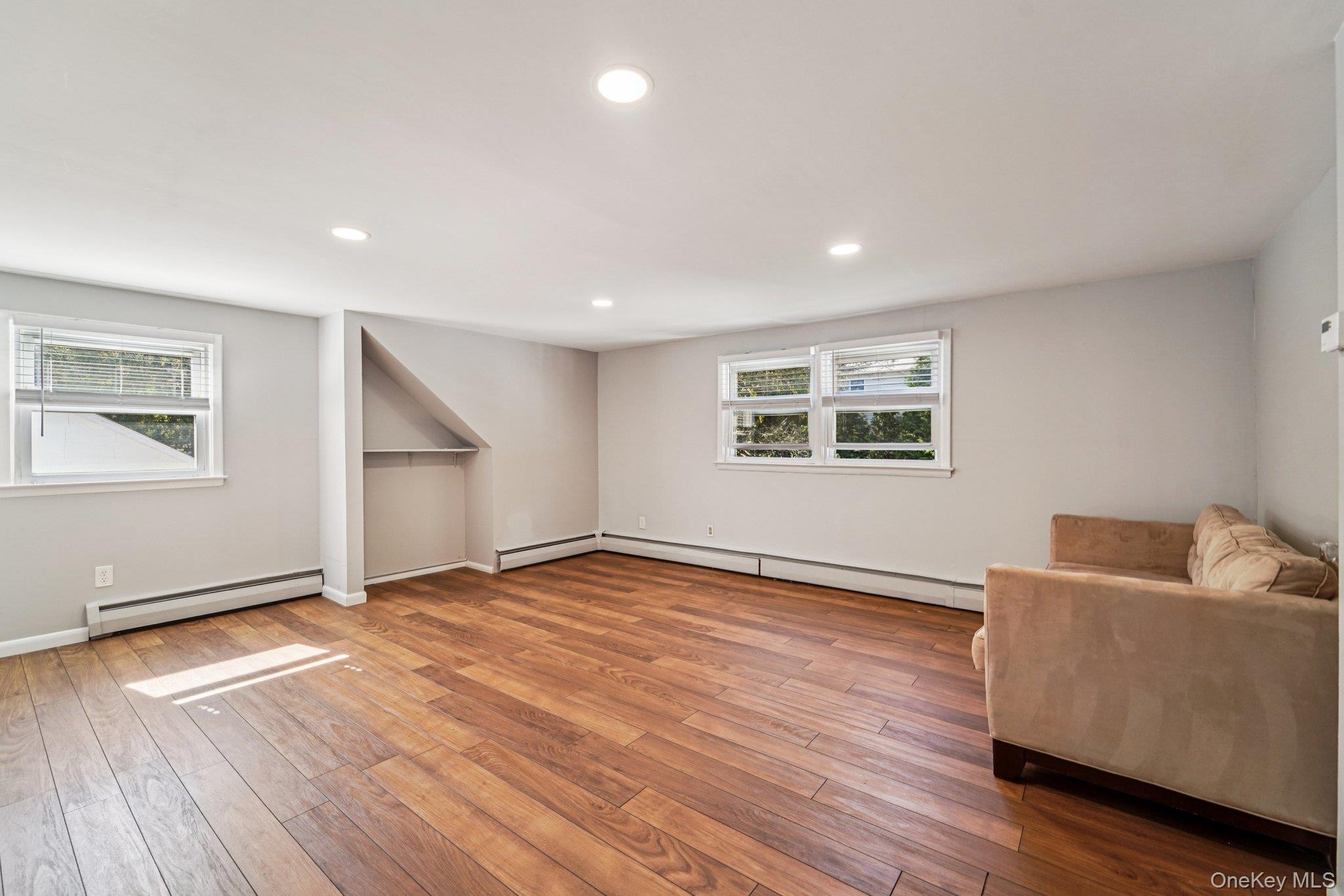 252 County Center Road White Plains, NY 10603 - Photo 29 of 44 Unfurnished room featuring recessed lighting, a baseboard radiator, and hardwood / wood-style floors