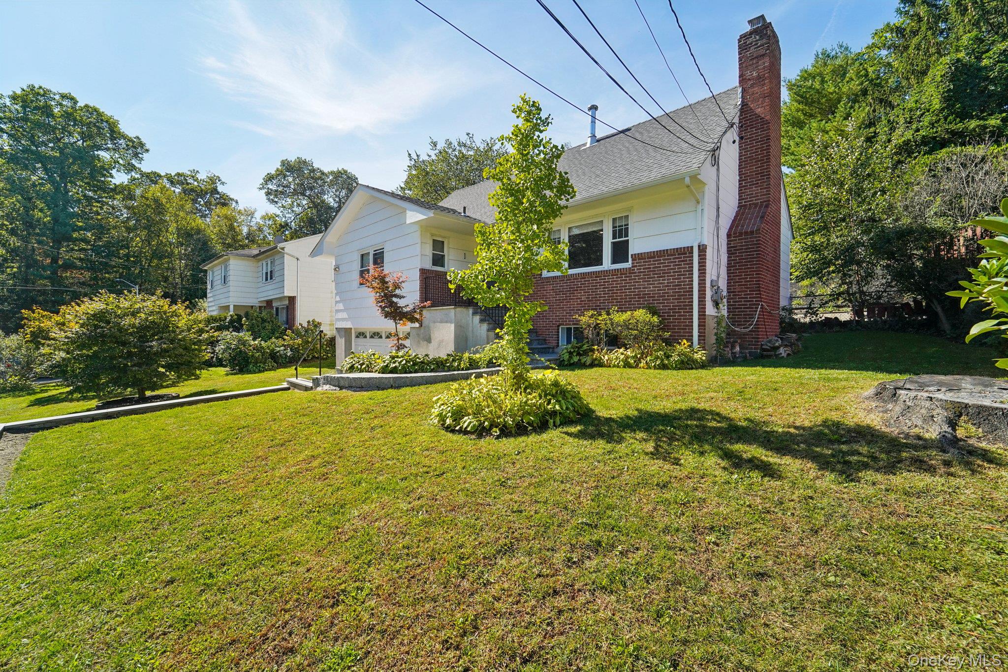 252 County Center Road White Plains, NY 10603 - Photo 34 of 44 View of front of property with a chimney, a front lawn, brick siding, and roof with shingles