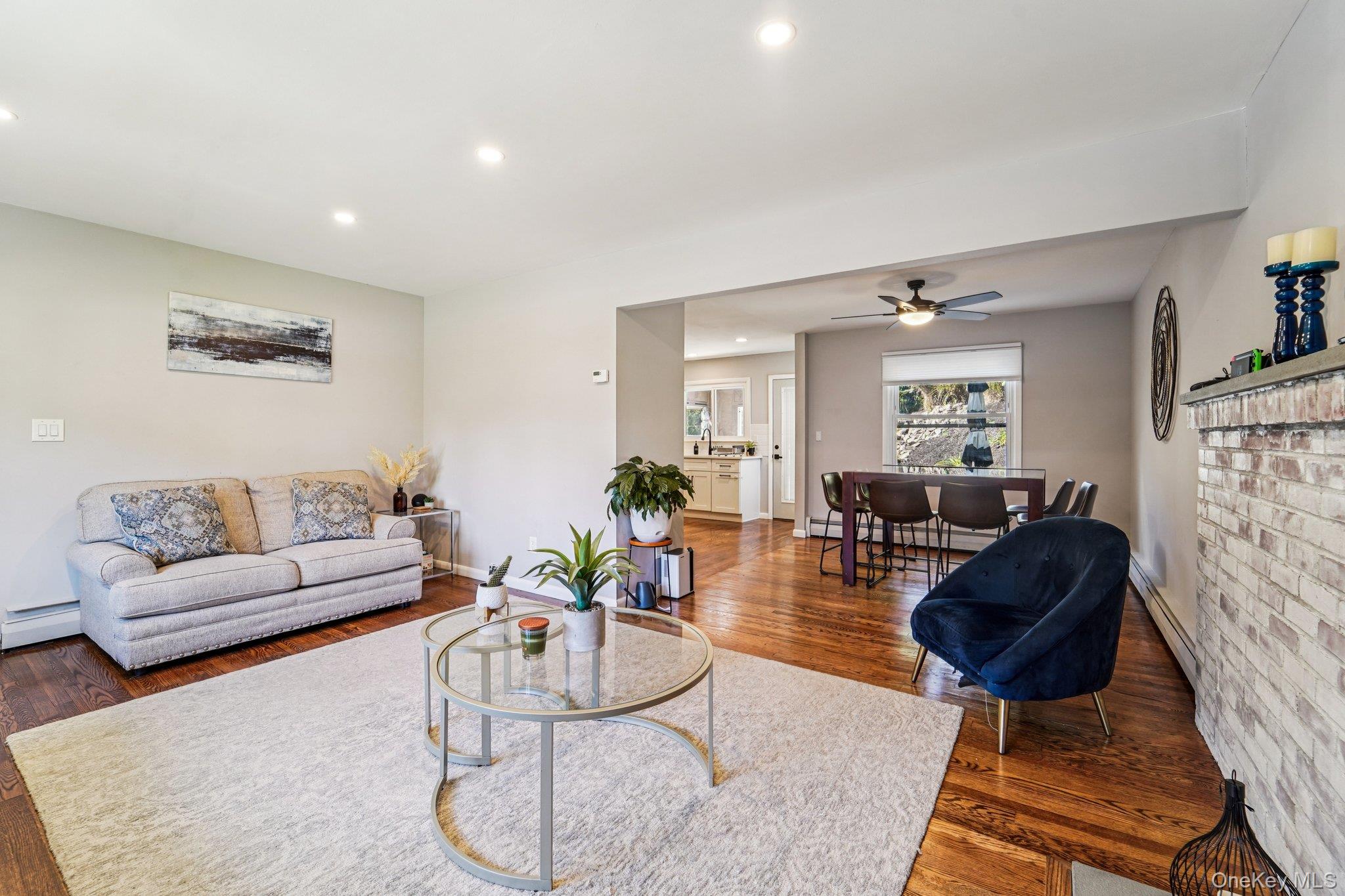 252 County Center Road White Plains, NY 10603 - Photo 4 of 44 Living room featuring recessed lighting, dark wood-style floors, a baseboard heating unit, a baseboard radiator, and a ceiling fan