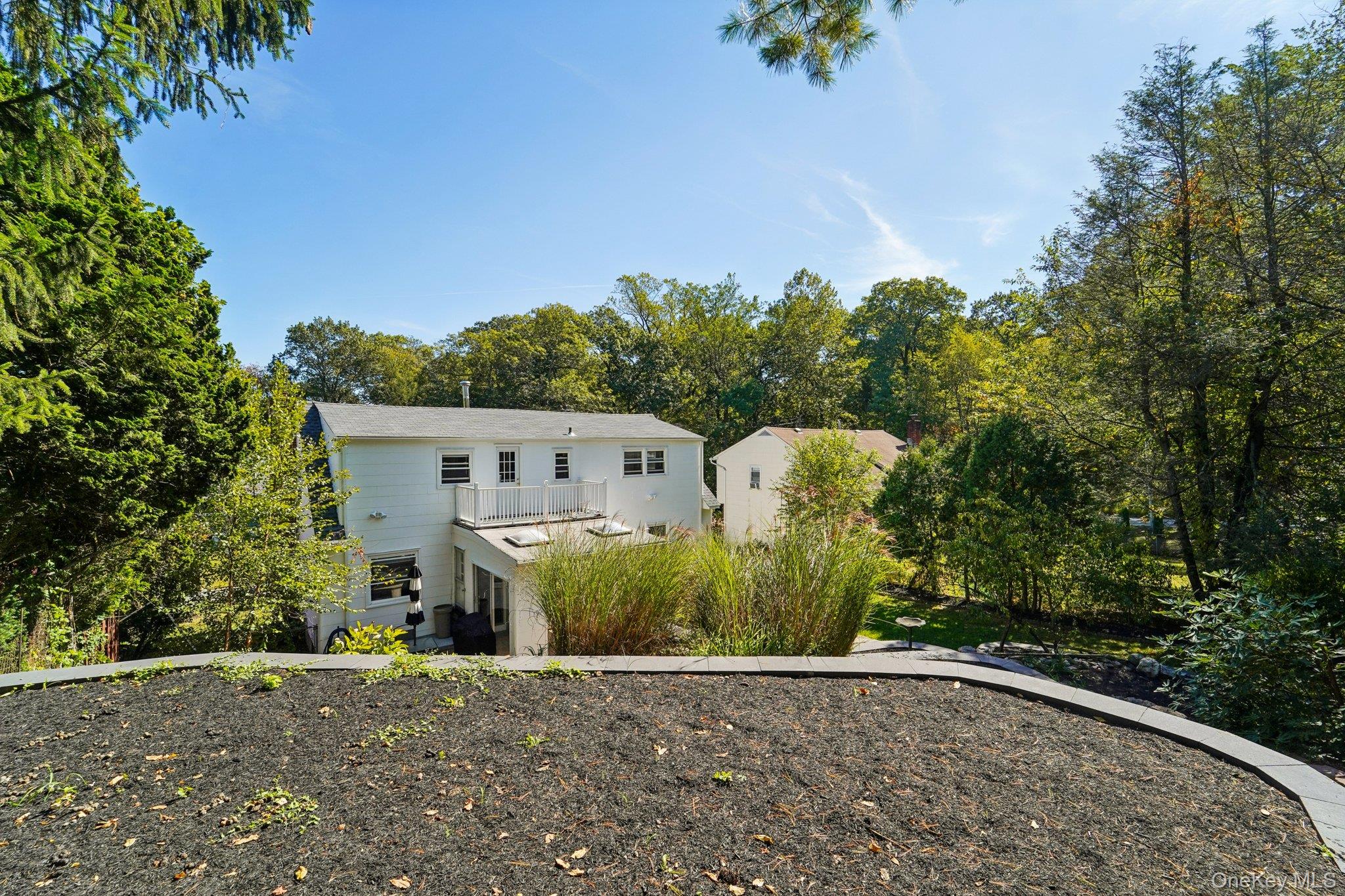 252 County Center Road White Plains, NY 10603 - Photo 42 of 44 Back of property featuring view of wooded area and a balcony