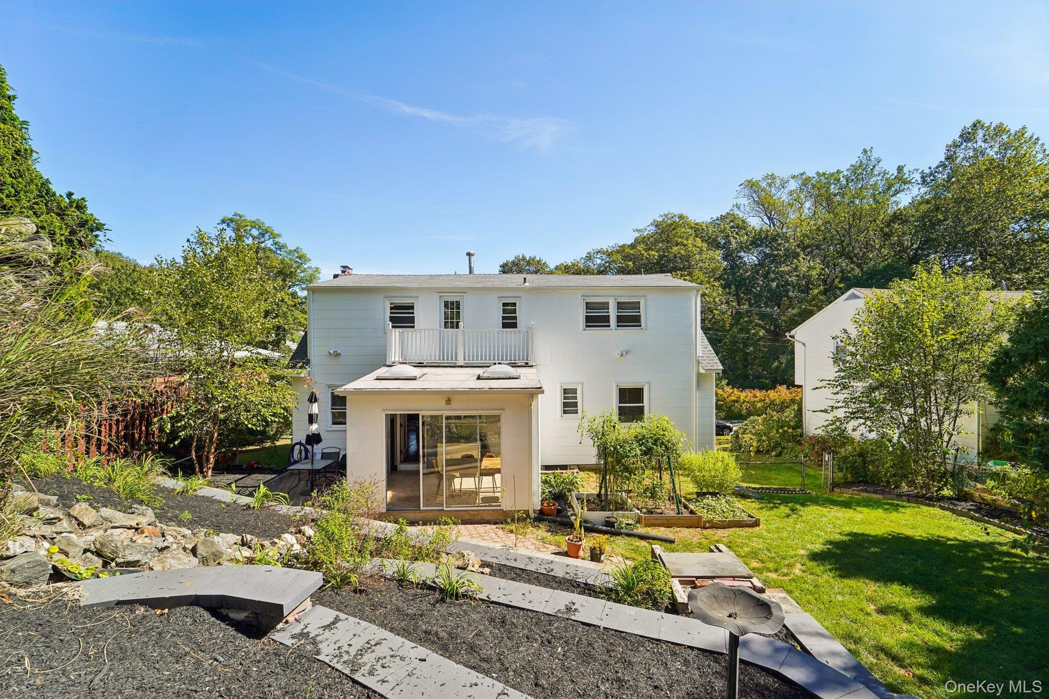 252 County Center Road White Plains, NY 10603 - Photo 43 of 44 Back of house featuring a garden, a yard, and a balcony