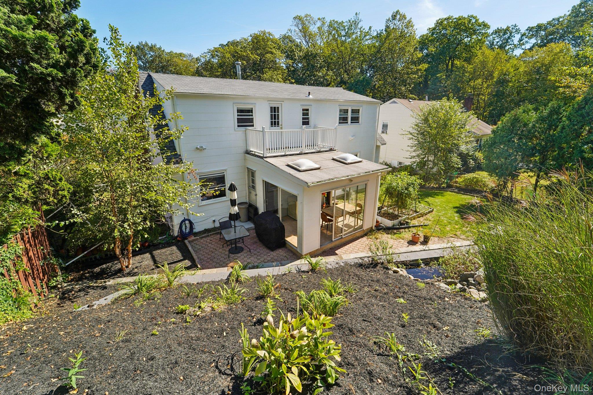 252 County Center Road White Plains, NY 10603 - Photo 44 of 44 Back of property with a balcony, a sunroom, and a patio area