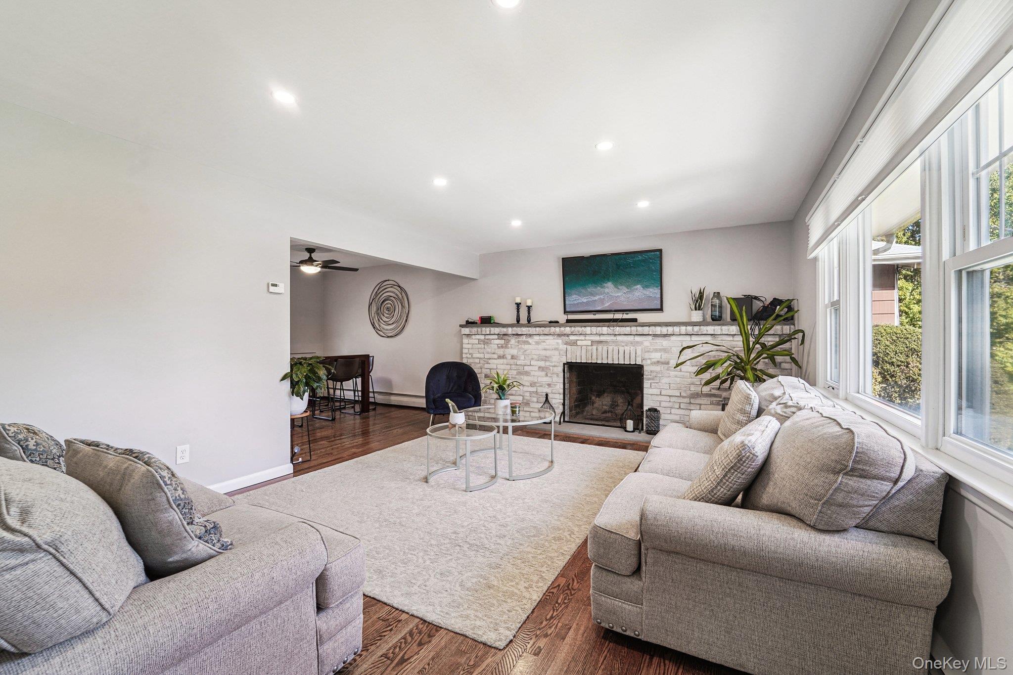 252 County Center Road White Plains, NY 10603 - Photo 5 of 44 Living room featuring wood finished floors, recessed lighting, a brick fireplace, and ceiling fan
