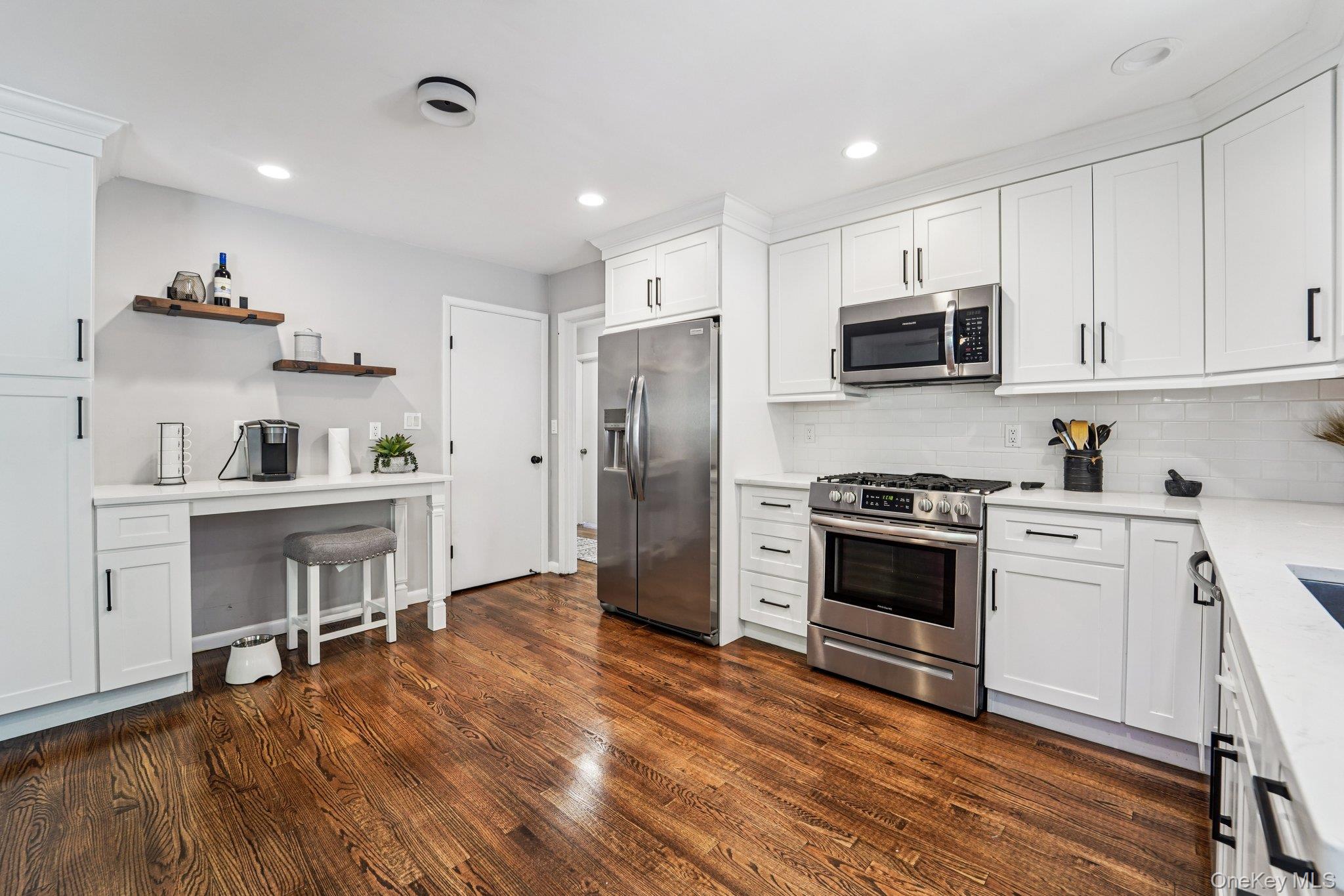 252 County Center Road White Plains, NY 10603 - Photo 7 of 44 Kitchen featuring white cabinets, stainless steel appliances, recessed lighting, decorative backsplash, and dark wood finished floors