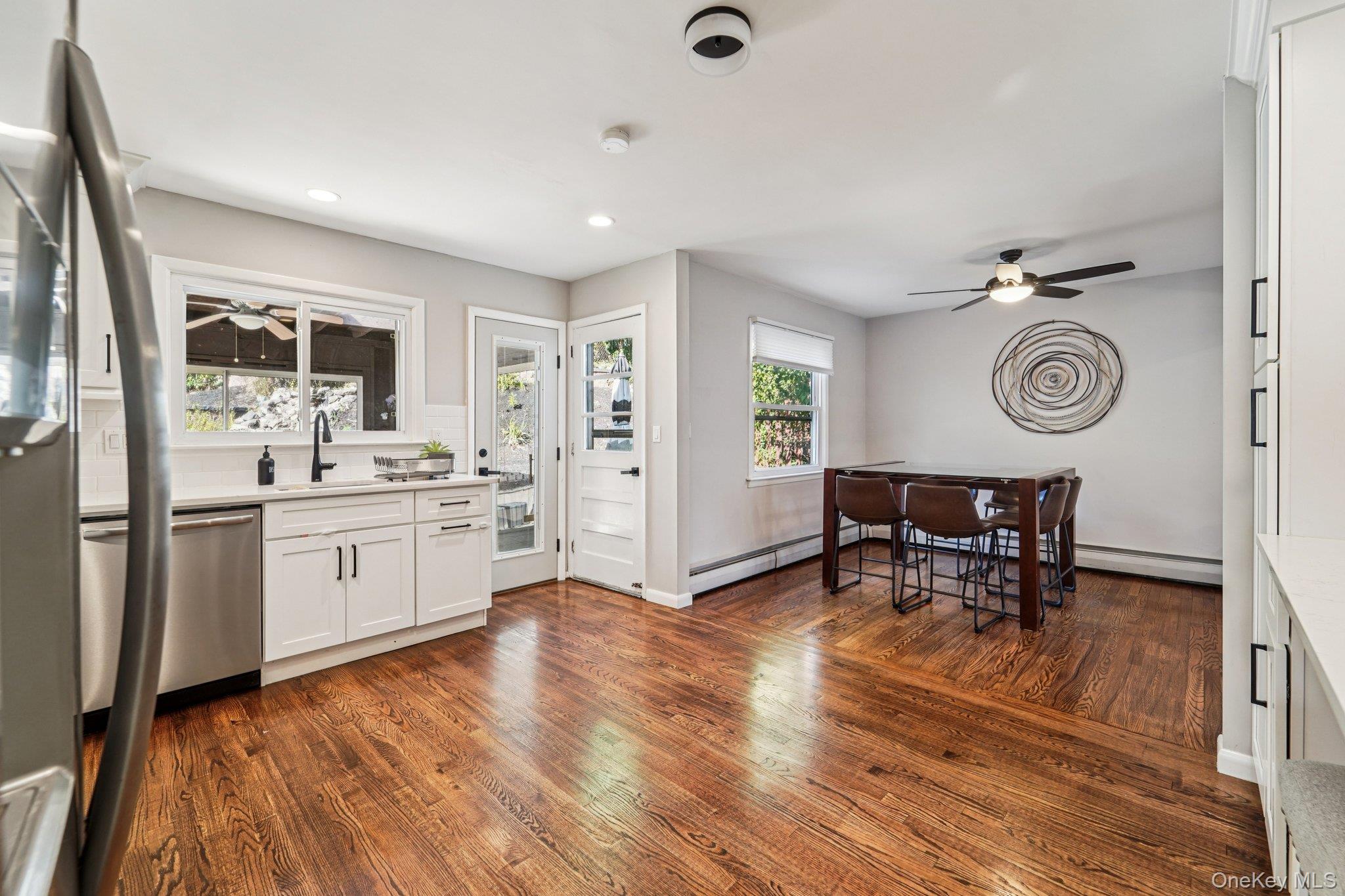 252 County Center Road White Plains, NY 10603 - Photo 8 of 44 Kitchen with a ceiling fan, white cabinets, stainless steel appliances, dark wood finished floors, and recessed lighting