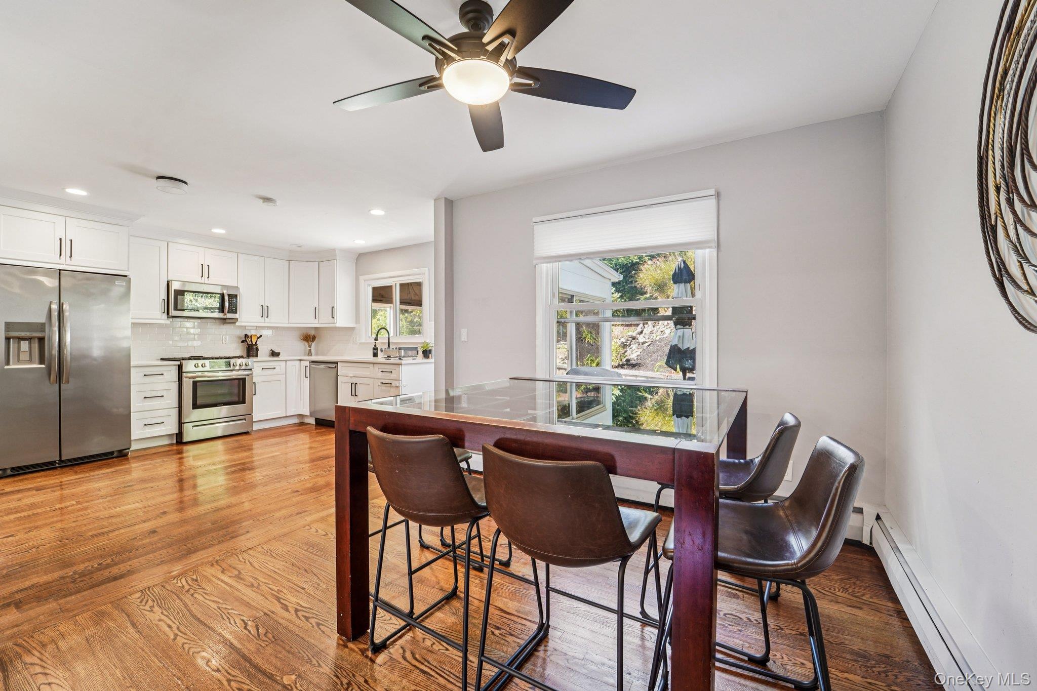 252 County Center Road White Plains, NY 10603 - Photo 9 of 44 Dining area featuring a baseboard heating unit, light wood-type flooring, a ceiling fan, and recessed lighting